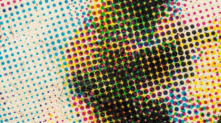CMYK halftone pattern on textured vintage paper